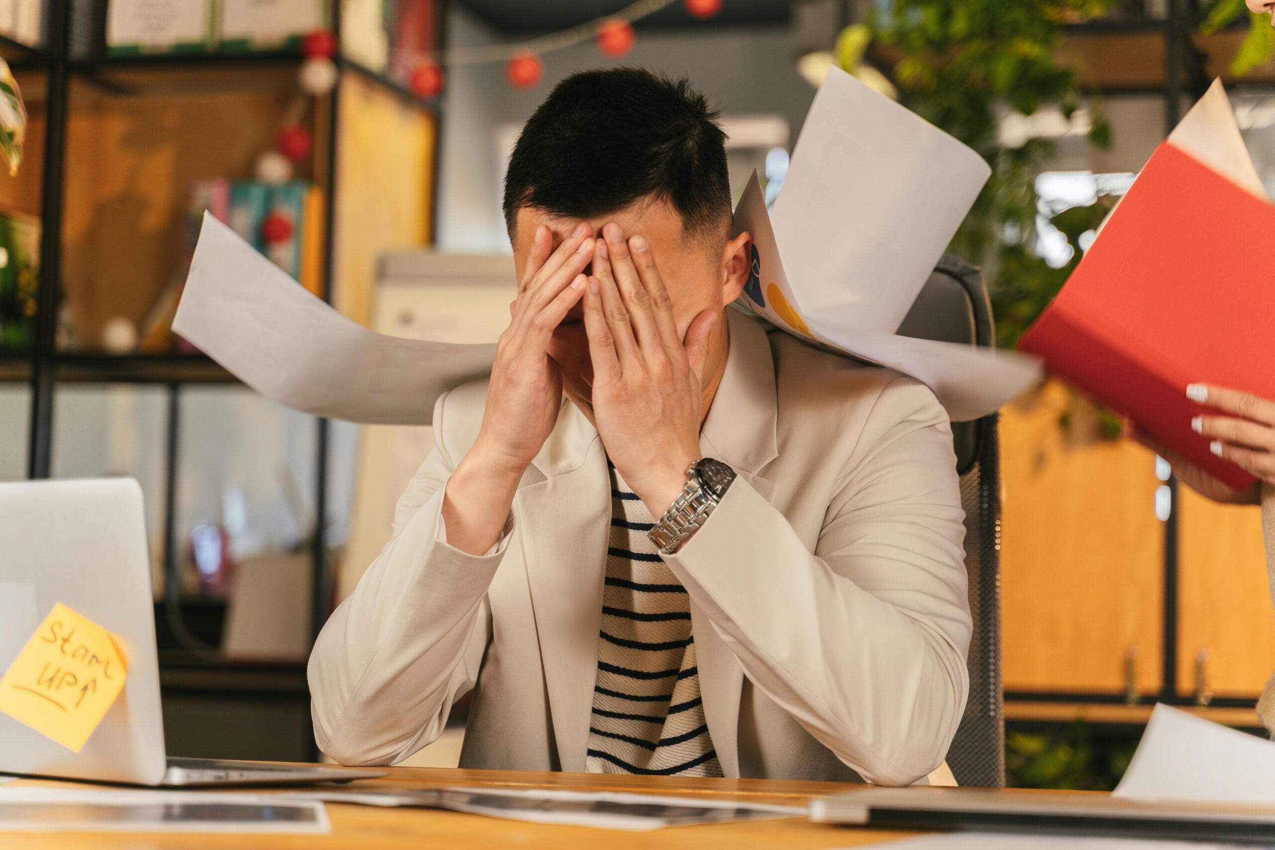 A stressed entrepreneur looking at documents related to a patent lawsuit