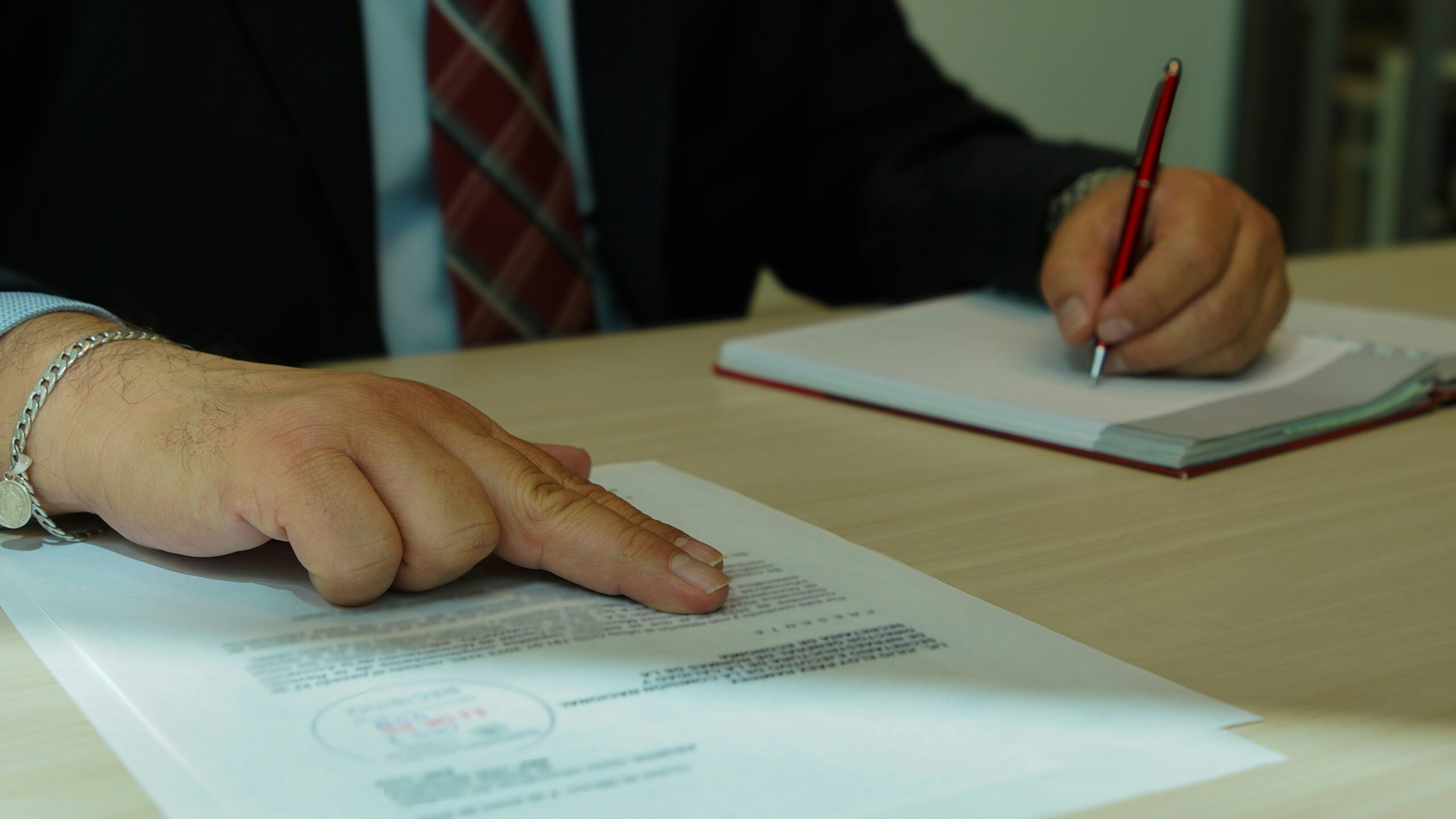 A desk cluttered with documents and sticky notes detailing infringement cases
