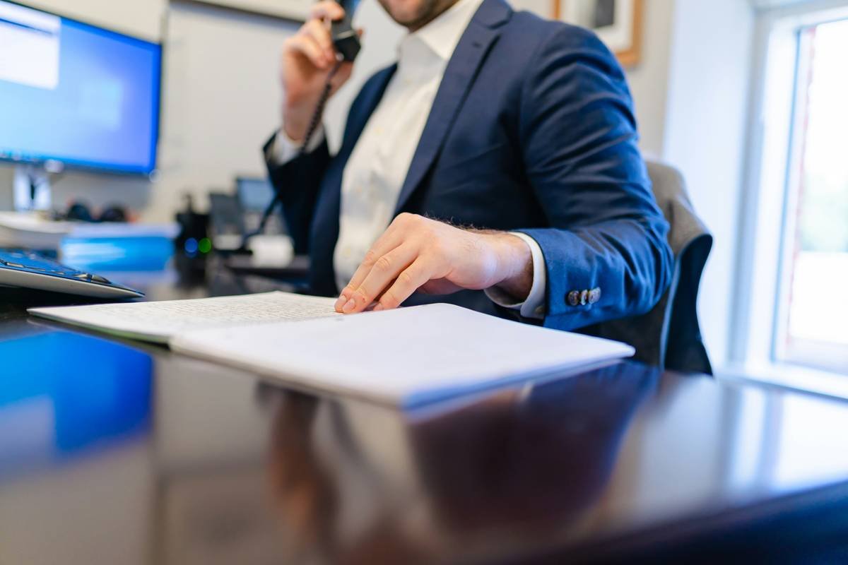 patent defense legal evidence costs illustrated by stacks of documents, digital forensics tools, and expert witness invoices
